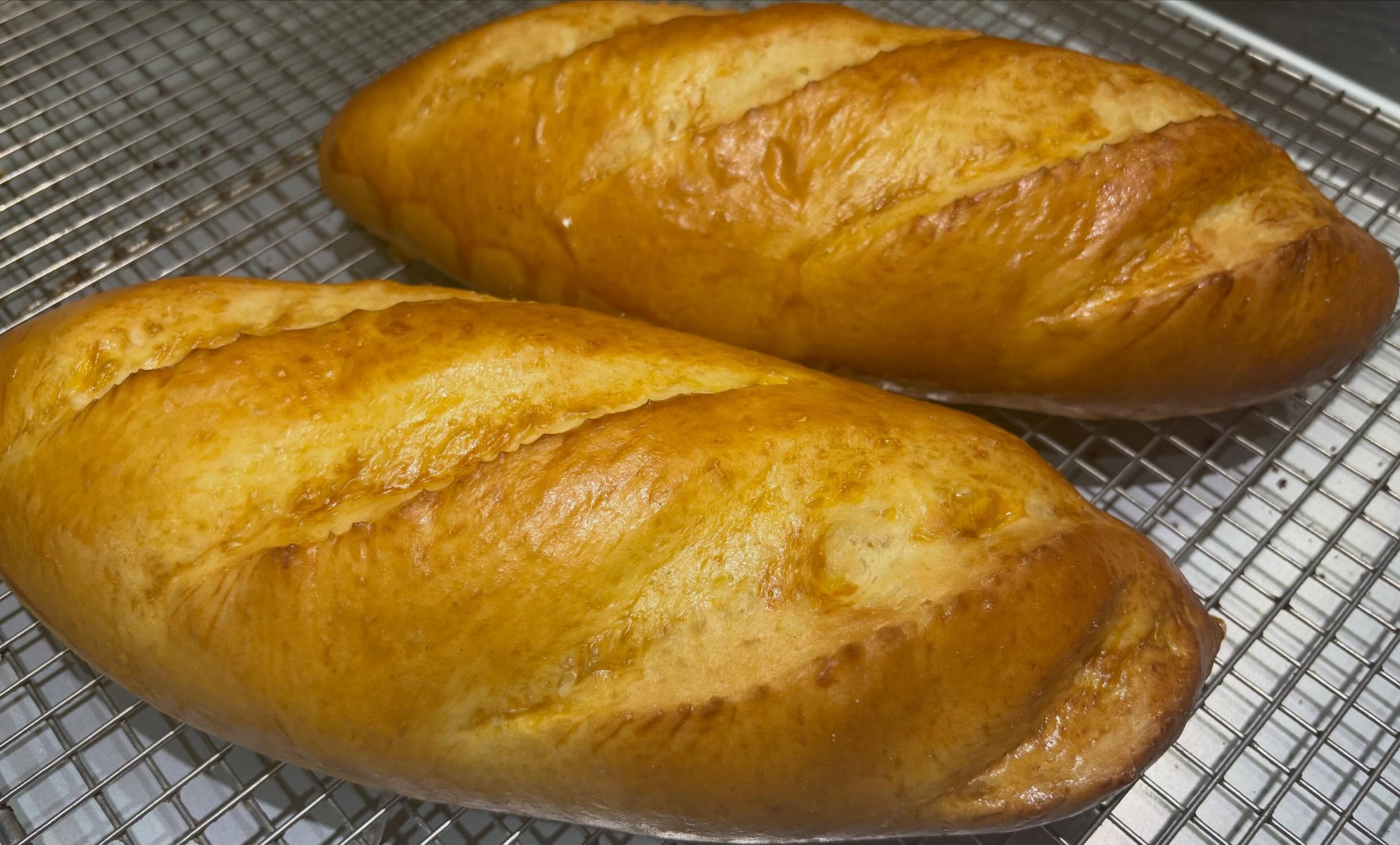 Freshly baked Panderosa bread loaves cooling on a rack